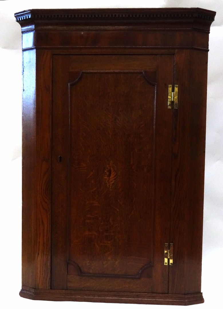 Appraisal: A George III oak and mahogany wall hanging corner cabinet