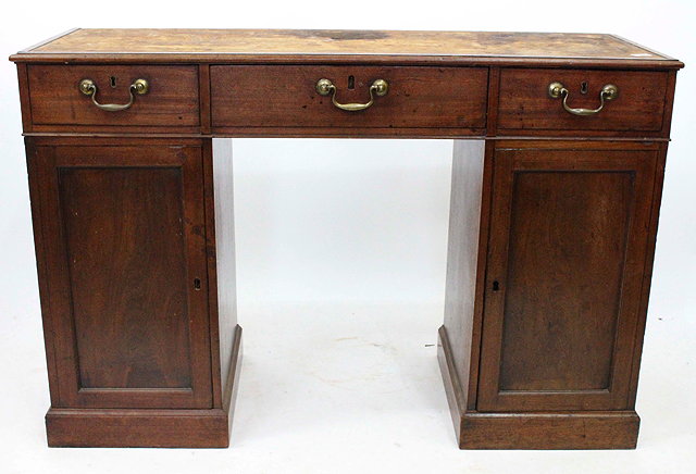 Appraisal: A GEORGE III MAHOGANY PEDESTAL DESK with three drawers having