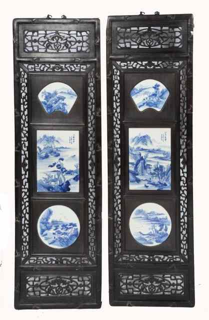 Appraisal: A PAIR OF CHINESE CARVED HARDWOOD PANELS each inset with