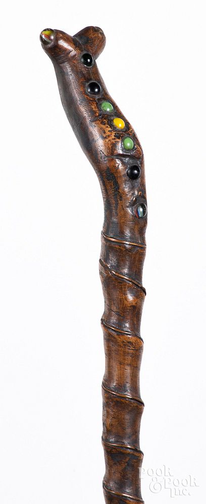 Appraisal: Carved walking stick ca Carved walking stick ca with inset