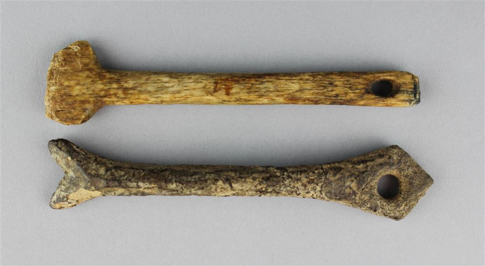 Appraisal: TWO NORTHWEST COAST CARVED BONE IMPLEMENTS POSSIBLY ARROW STRAIGHTENERS length