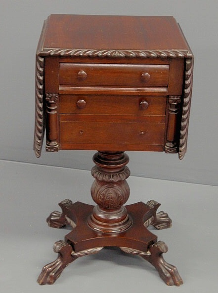 Appraisal: Empire style mahogany three-drawer stand with drop leaves h x