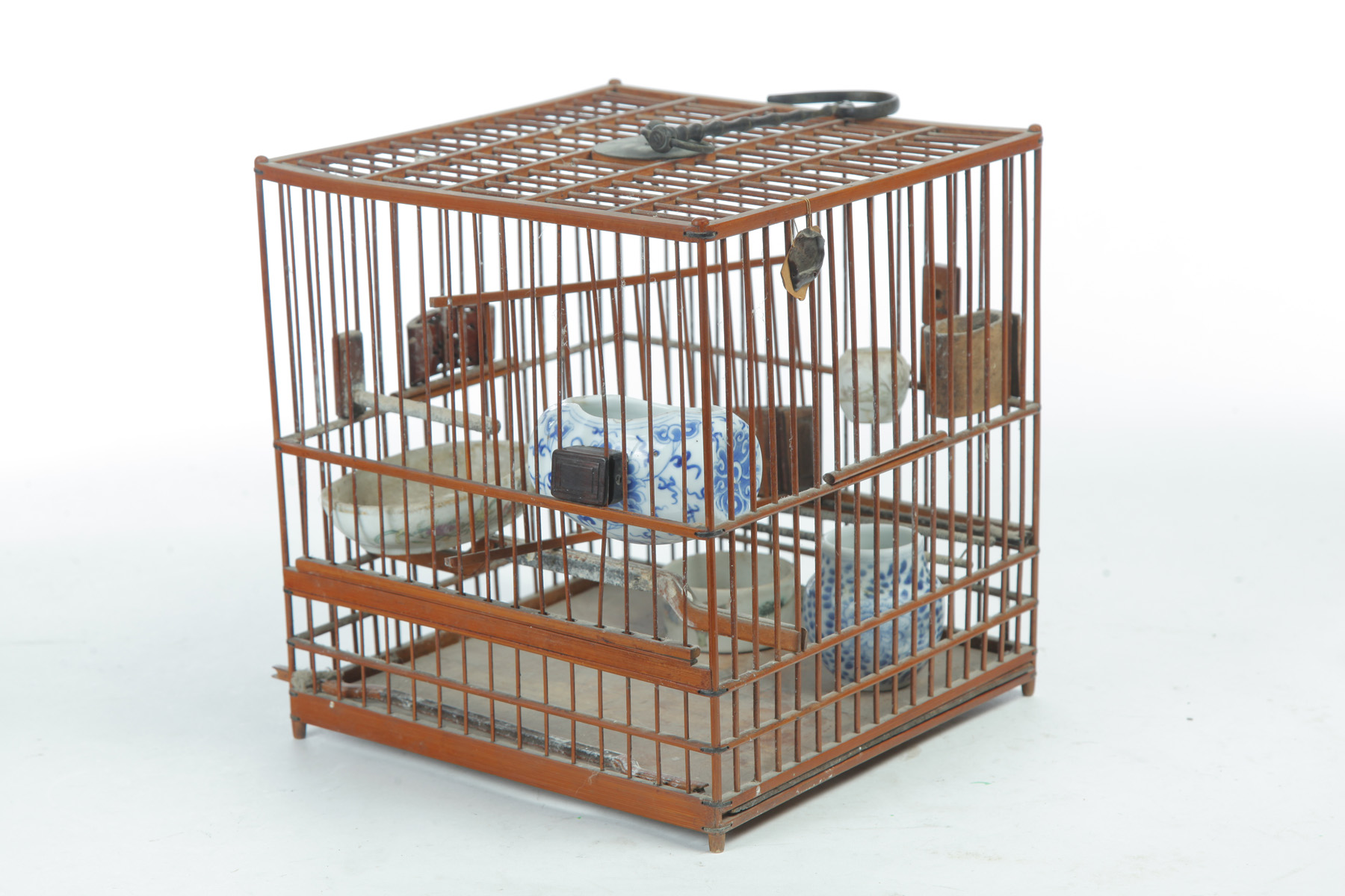 Appraisal: CHINESE BAMBOO BIRDCAGE Twentieth century Filled with several food and