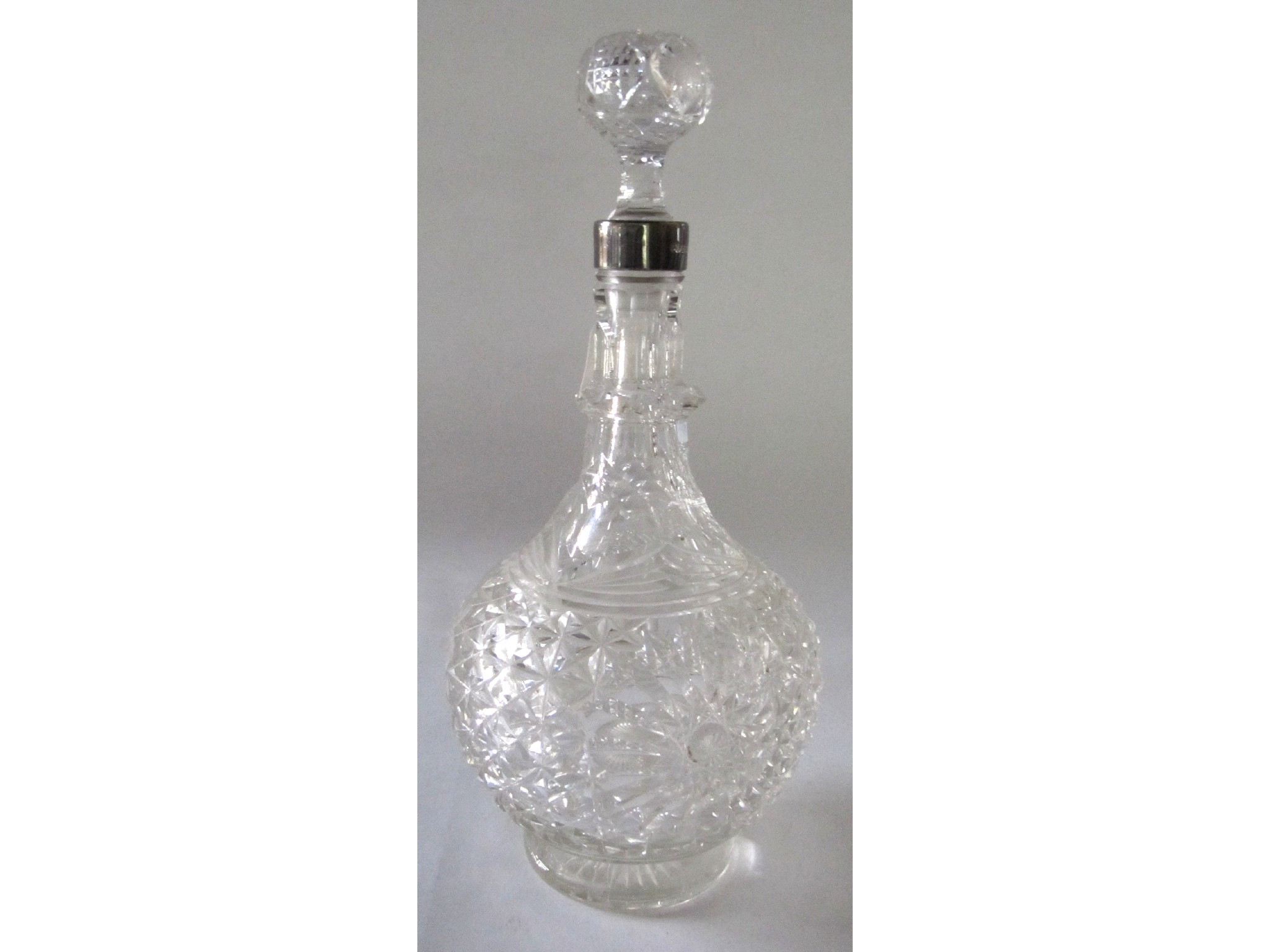 Appraisal: A cut glass decanter with silver collar Sheffield