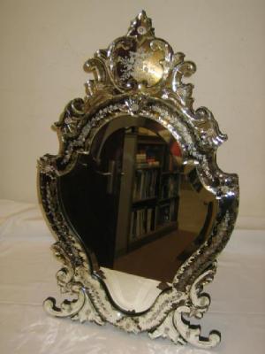 Appraisal: A VENETIAN WALL STRUT MIRROR of shield form with adjustable