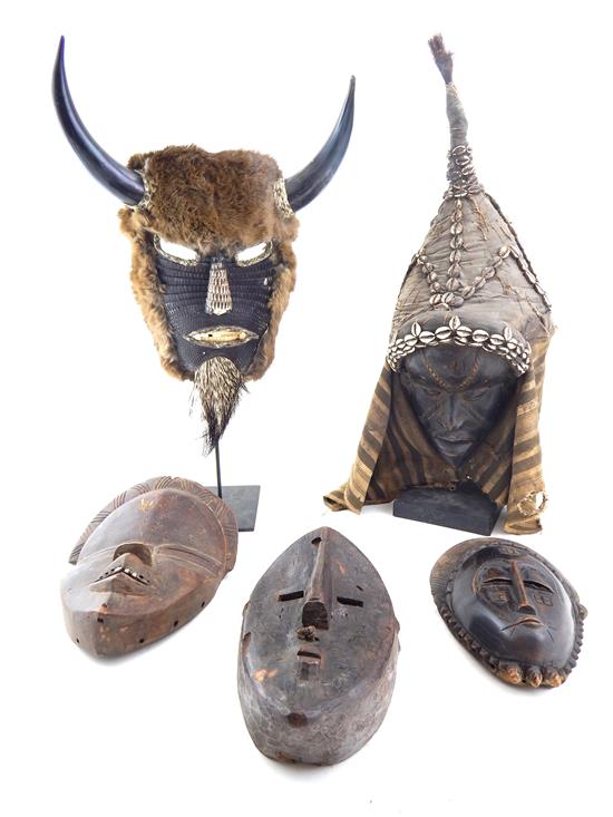 Appraisal: TRIBAL Four carved African masks and one American Indian Dan