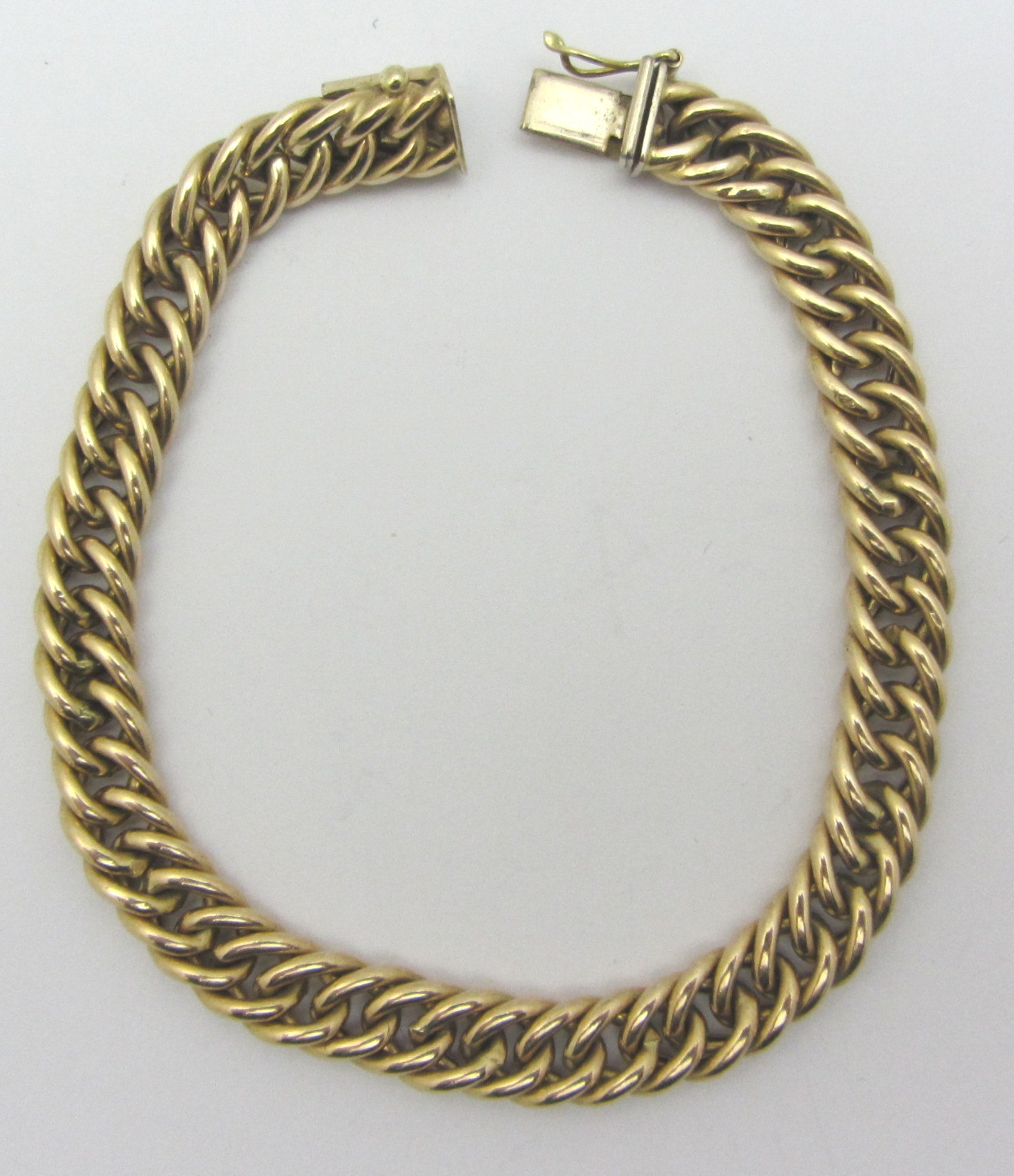 Appraisal: A gold curb link bracelet on a snap clasp detailed