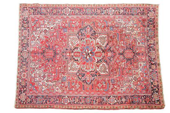 Appraisal: ORIENTAL RUG Room size Heriz Dark blue borders and a