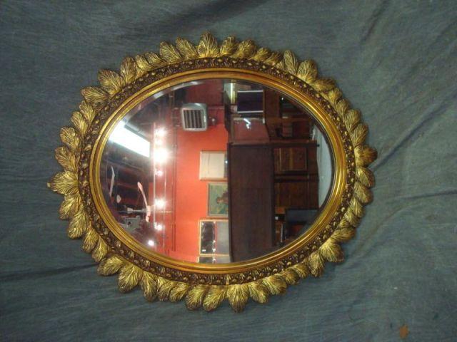 Appraisal: Oval Mirror with Giltwood Leaf Form Frame From a Southampton