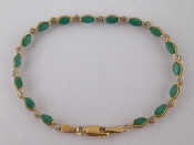 Appraisal: A yellow metal tests carat gold emerald and diamond bracelet