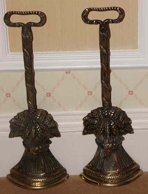 Appraisal: A PAIR OF BRASS GEORGIAN STYLE DOOR PORTERS with ribbon