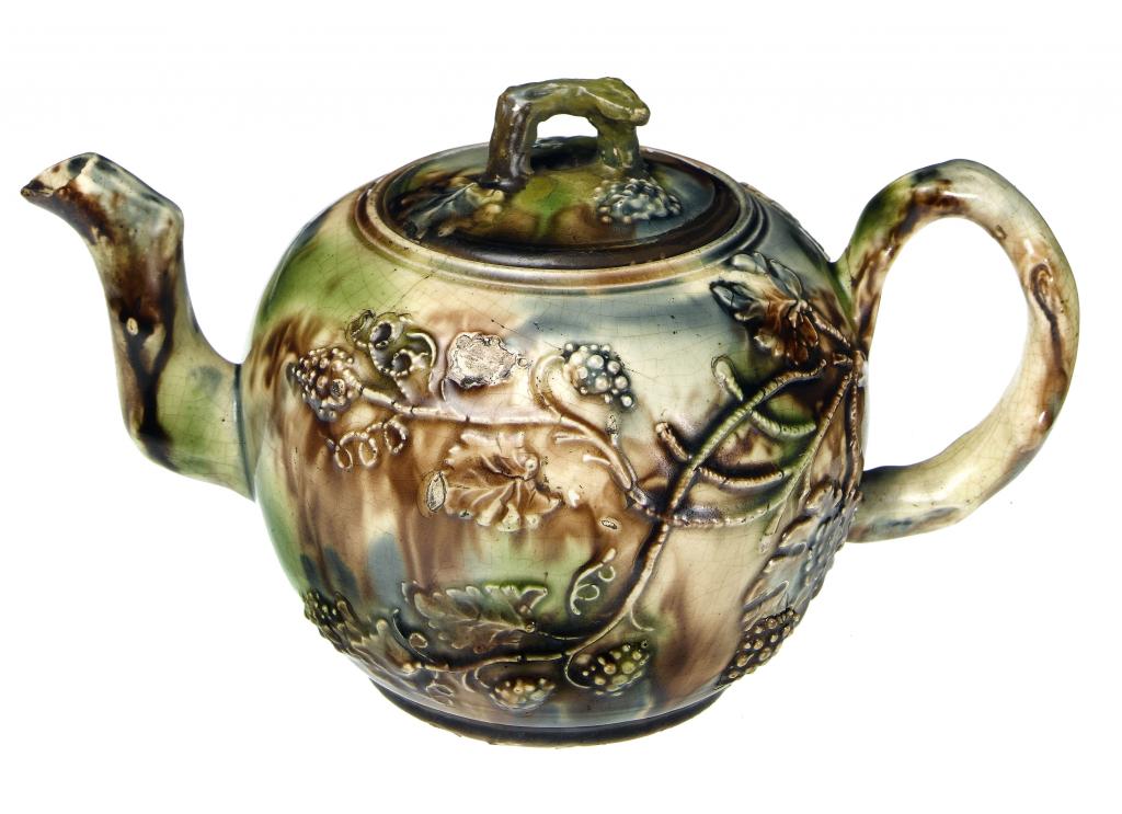 Appraisal: A STAFFORDSHIRE CREAMWARE GLOBULAR TEAPOT AND COVER sprigged with grapevines