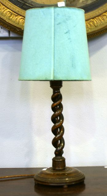 Appraisal: An oak table lamp with twisted stem cms high with