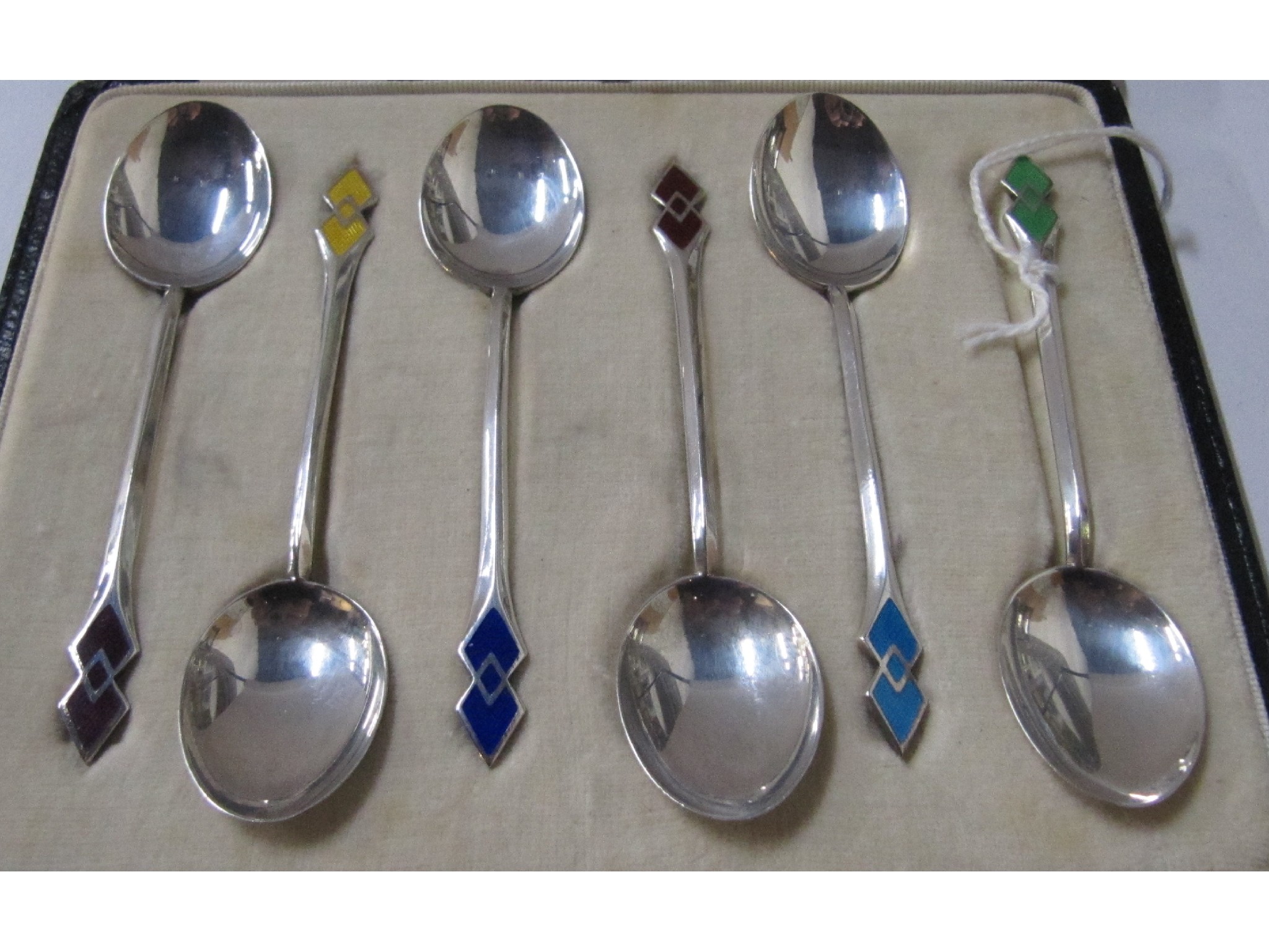 Appraisal: A cased set of six silver and enamel coffee spoons