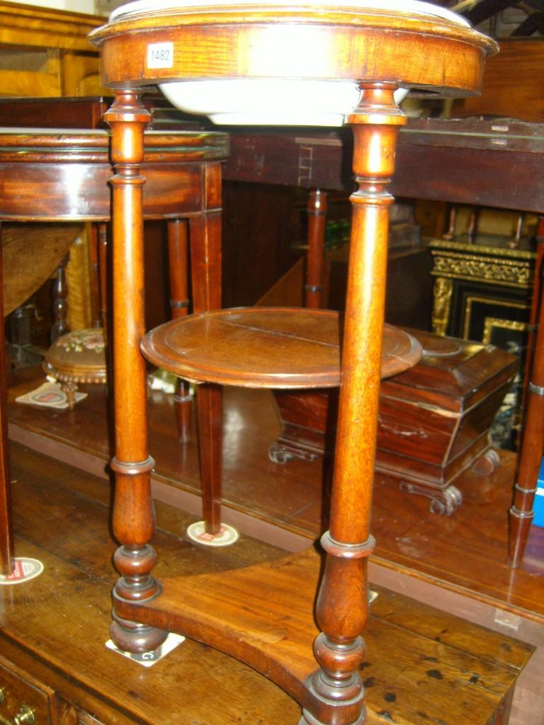 Appraisal: A th century mahogany -tier washstand of circular form raised