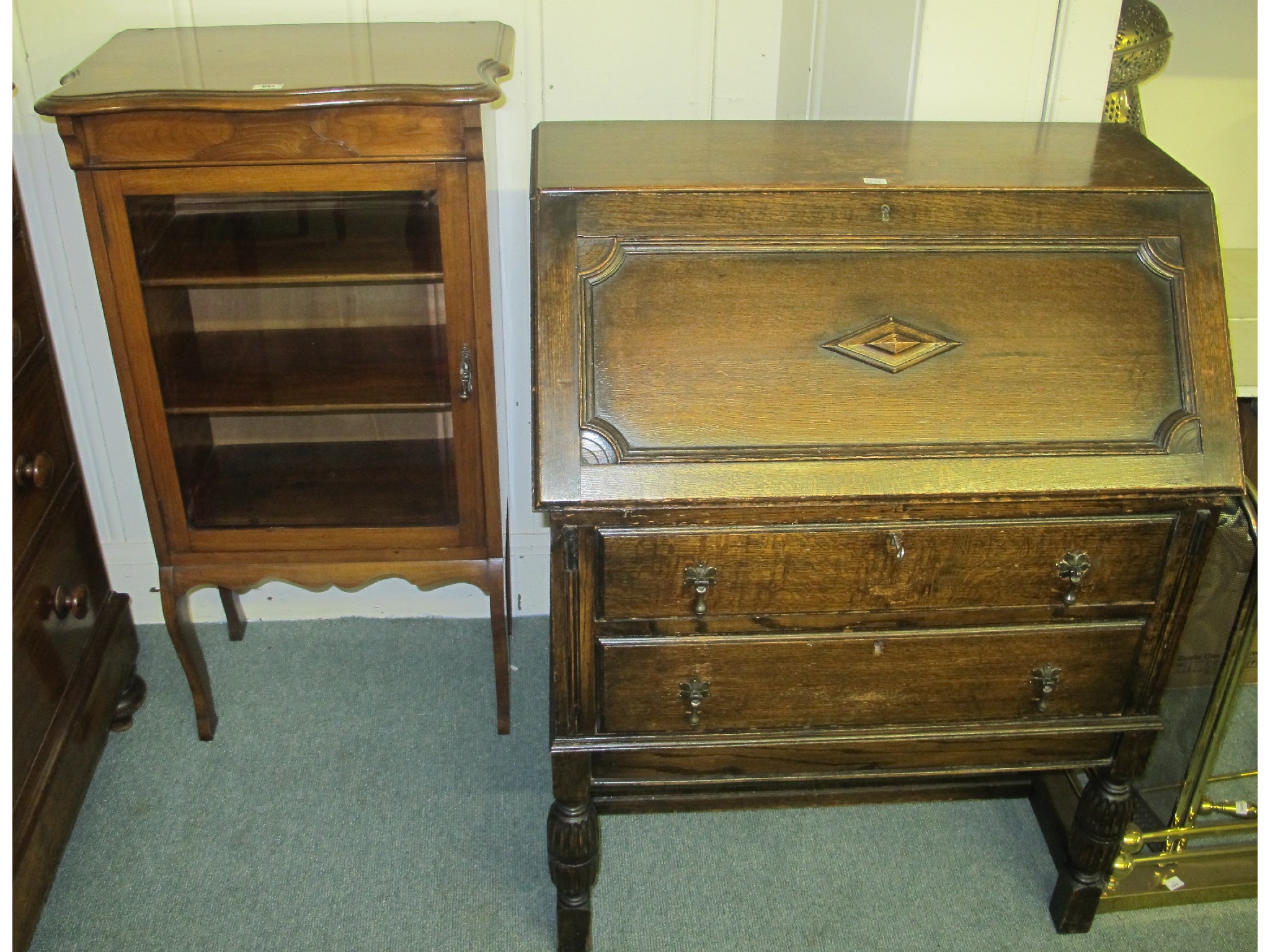 Appraisal: A mahogany music cabinet and an oak bureau