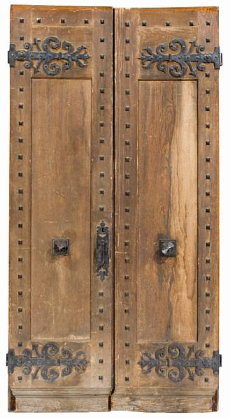 Appraisal: A pair of Baroque iron mounted hardwood doors Each paneled