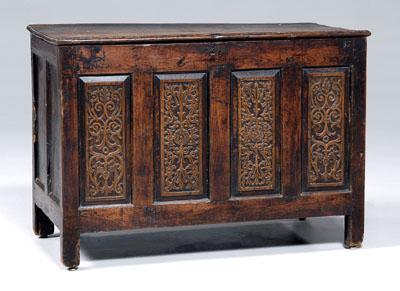 Appraisal: English carved oak lift-top chest four-panel front with carved strapwork