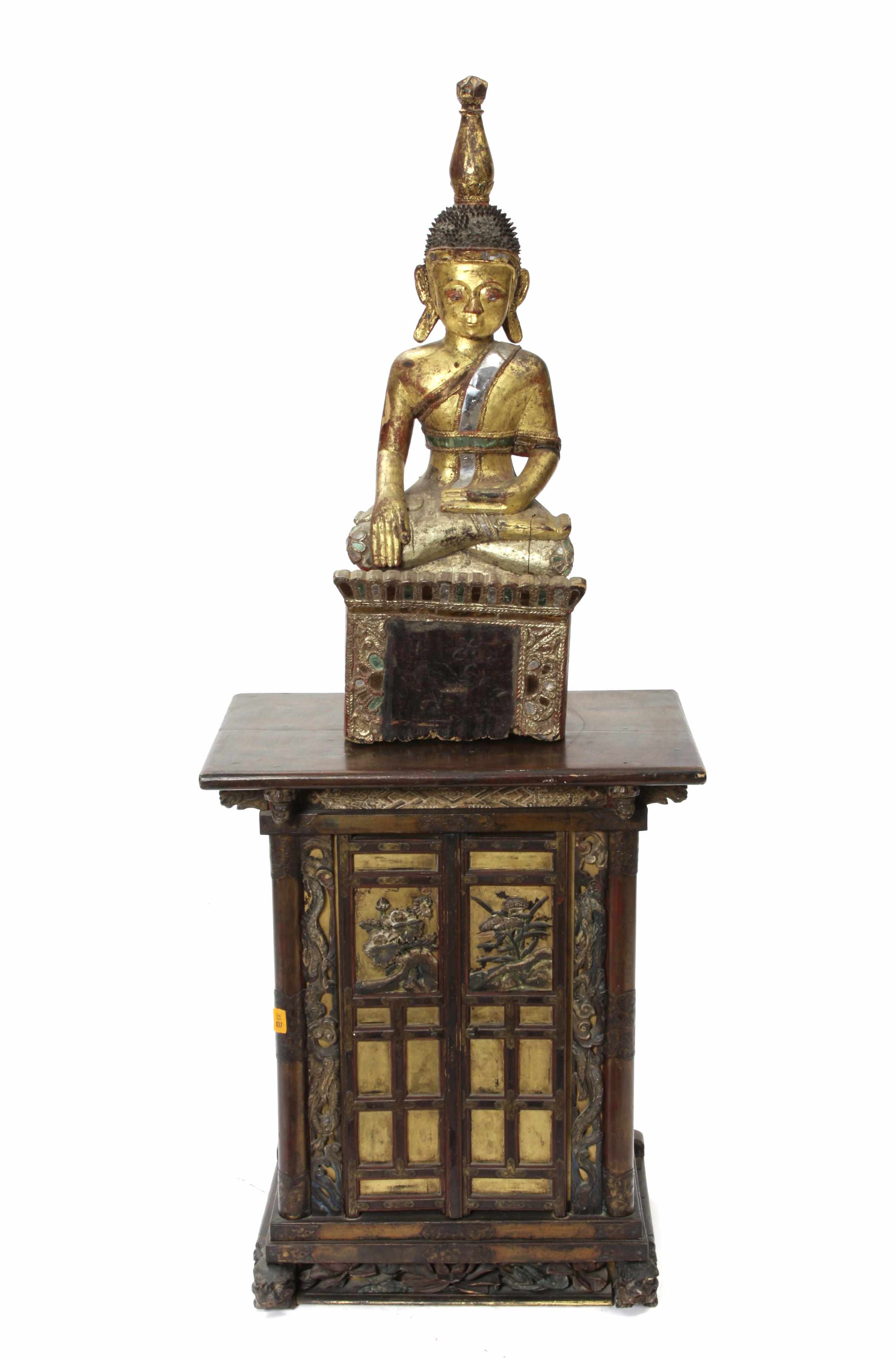 Appraisal: A polychrome and gilt decorated seated figure of a Buddha