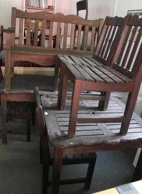 Appraisal: A suite of teak garden furniture comprising a bench four