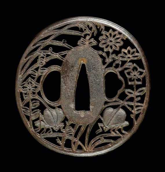 Appraisal: AN IRON NAGA-MARUGATA TSUBA IN THE AKASAKA-STYLE Japan Edo period