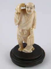 Appraisal: An ivory figure designed as a scholar probably Japanese on