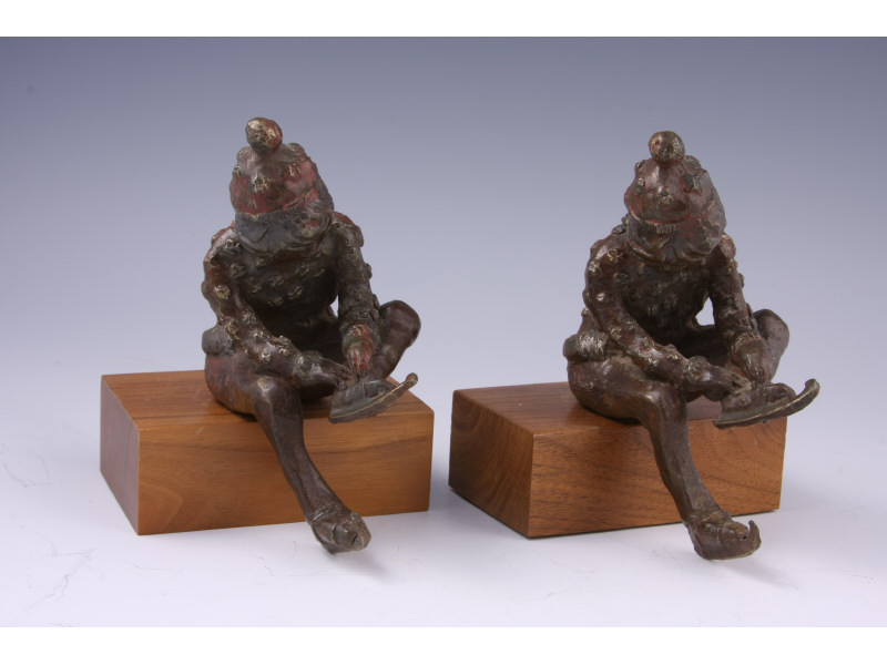 Appraisal: Bronze Figural Bookends depicting a seated youngster preparing to go