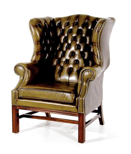 Appraisal: Georgian style tufted green leather wingchair th century serpentine back