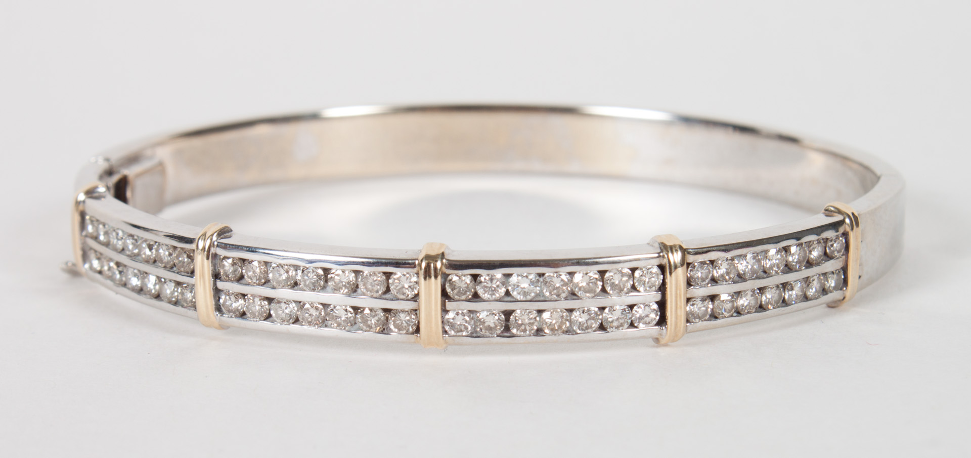 Appraisal: Lady's K white yellow gold bangle bracelet with diamonds inset