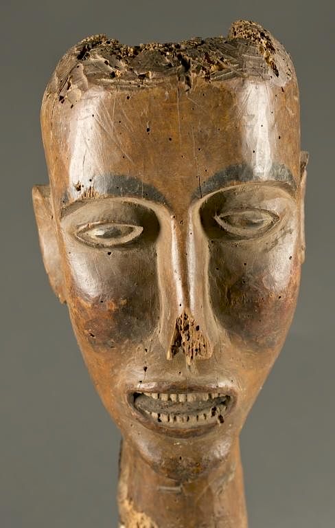 Appraisal: Polychrome head with barred teeth A woden head with teeth