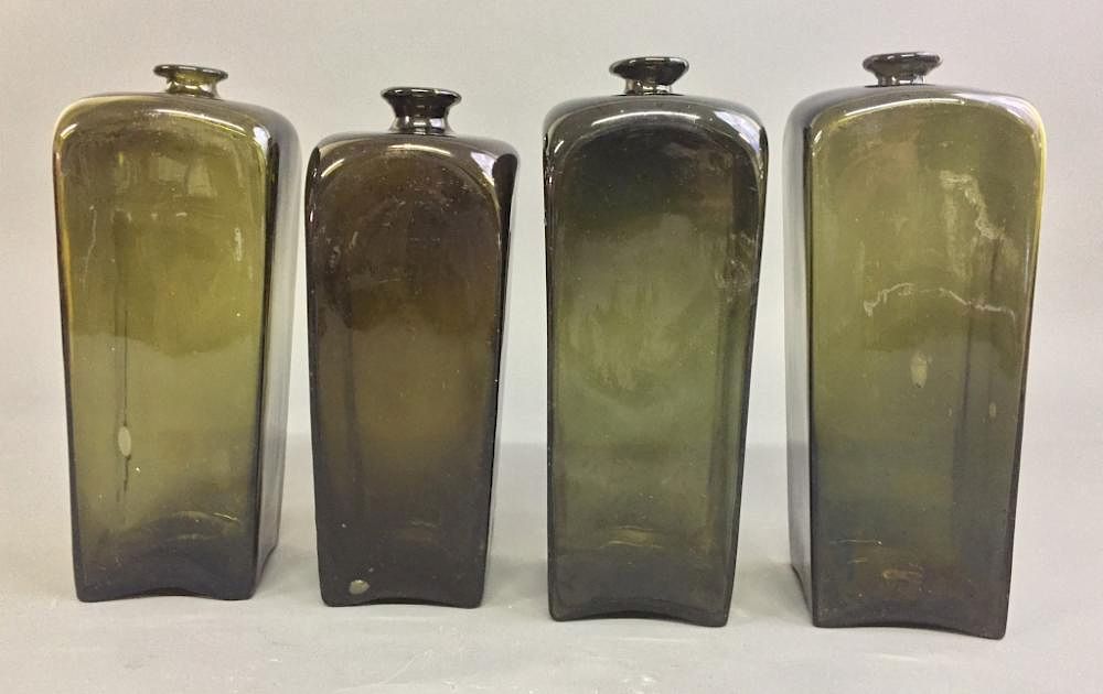 Appraisal: Four Green Blown Glass Bottles Four green blown glass bottles