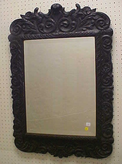 Appraisal: Black carved wood frame mirror foliate and scroll carving beveled