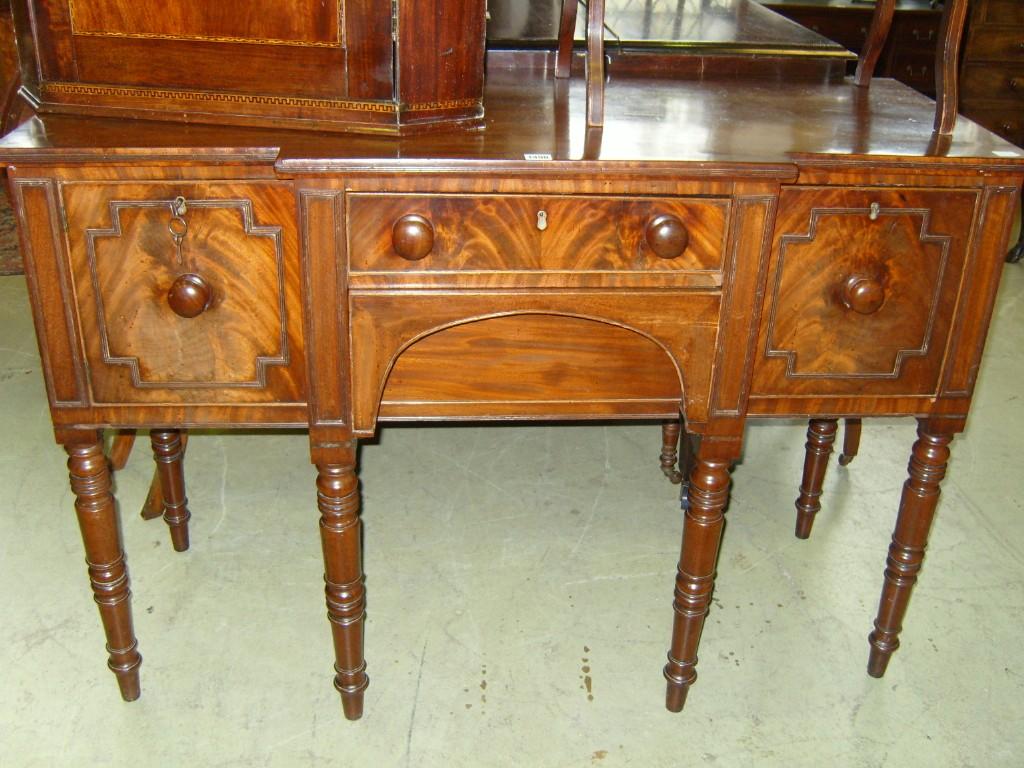 Appraisal: A small Georgian mahogany breakfront sideboard fitted with two long