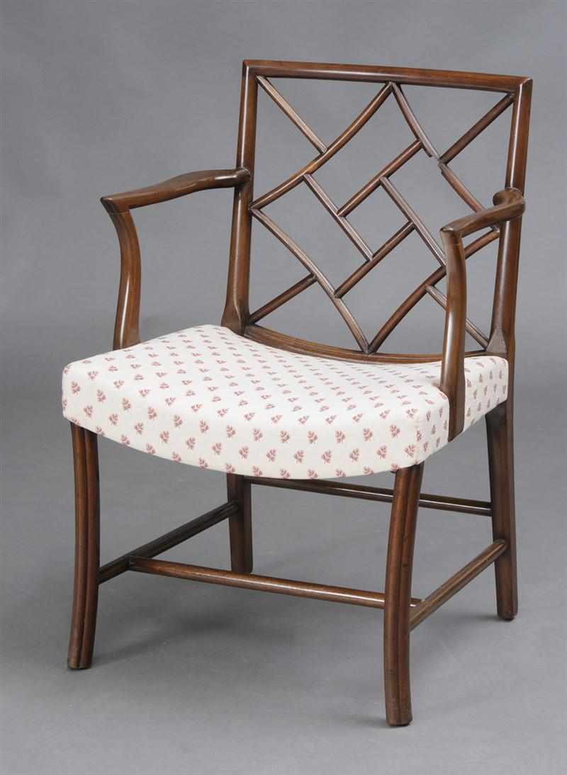 Appraisal: GEORGE III STYLE MAHOGANY COCKPEN ARMCHAIR The pierced lattice back