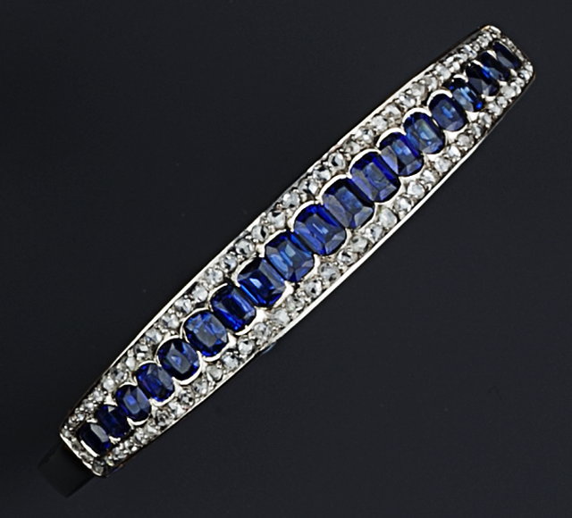 Appraisal: A SAPPHIRE AND DIAMOND SET BANGLE of hinged oval form