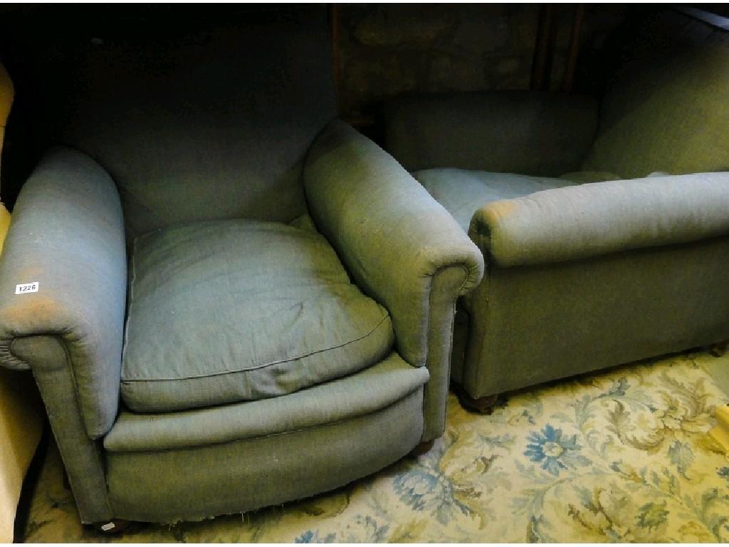 Appraisal: A pair of Edwardian easy chairs deep seated rolled arms