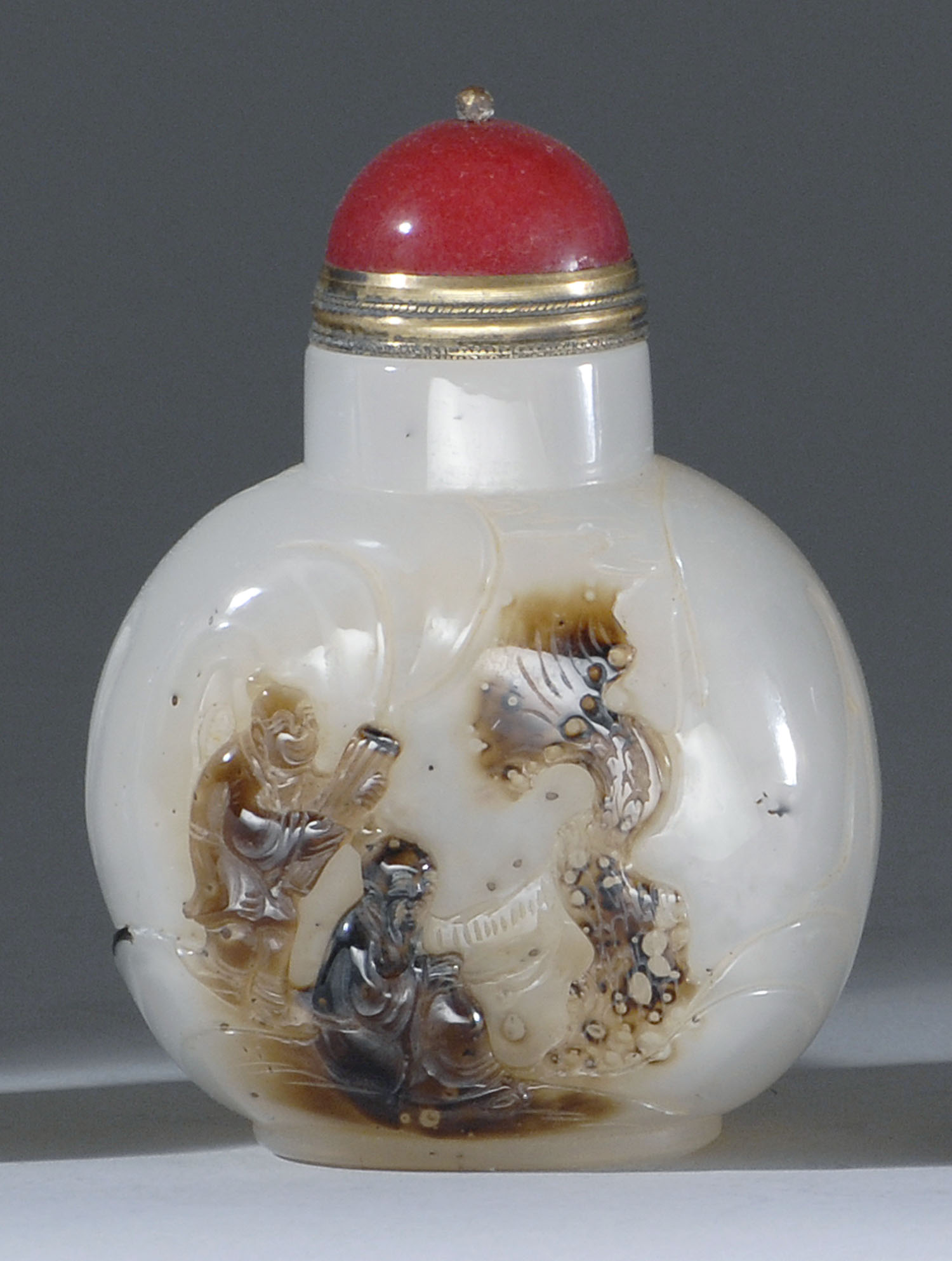 Appraisal: CHALCEDONY AGATE SNUFF BOTTLE In ovoid form with relief carving