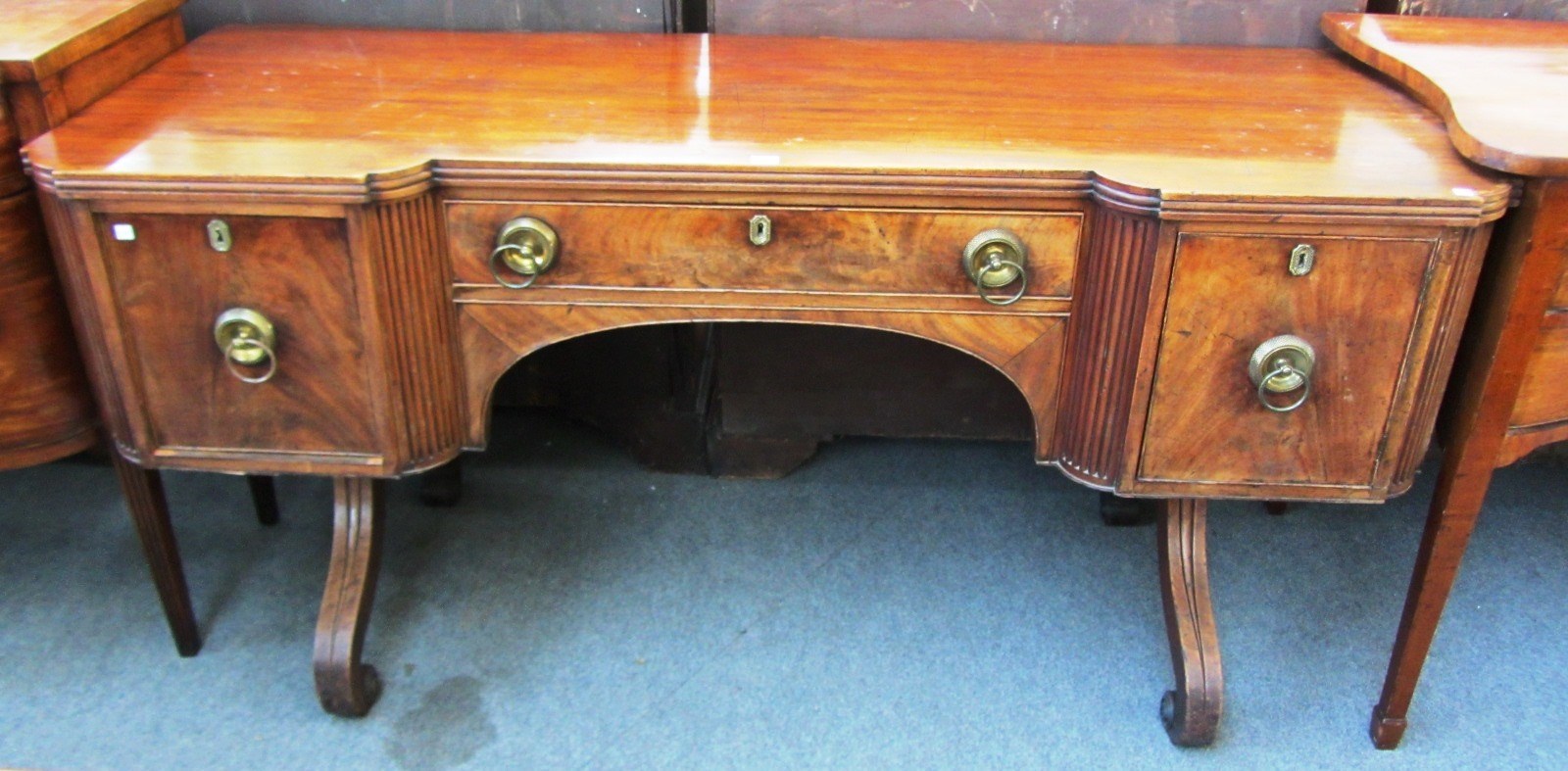 Appraisal: A Regency mahogany sideboard the inverted breakfront top with three