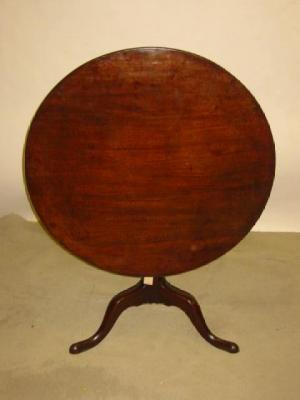 Appraisal: A GEORGE III MAHOGANY TRIPOD TABLE the circular tip up