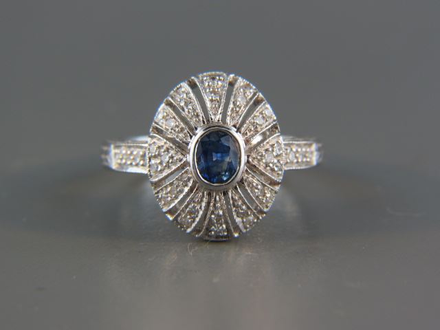 Appraisal: Sapphire and Diamond Ring oval blue gem weighing carat surrounded