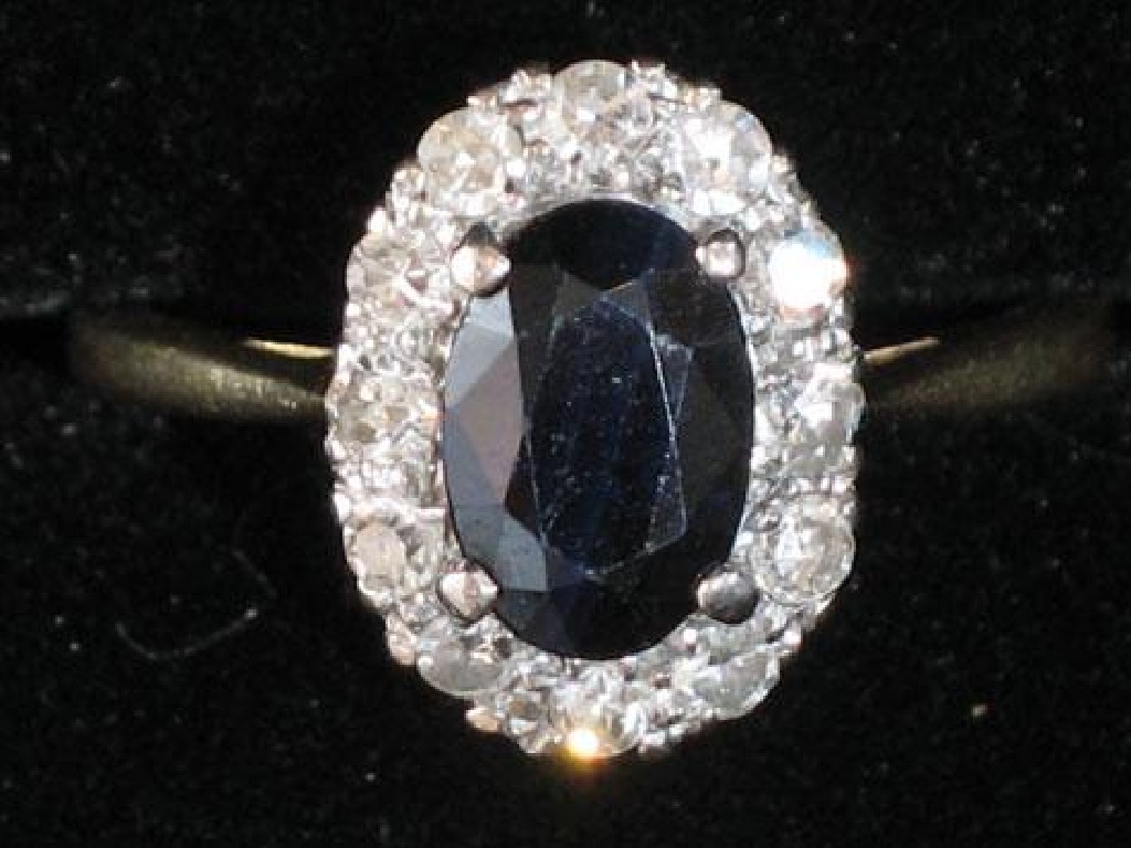 Appraisal: A SAPPHIRE AND DIAMOND CLUSTER RING the central oval cushion-cut