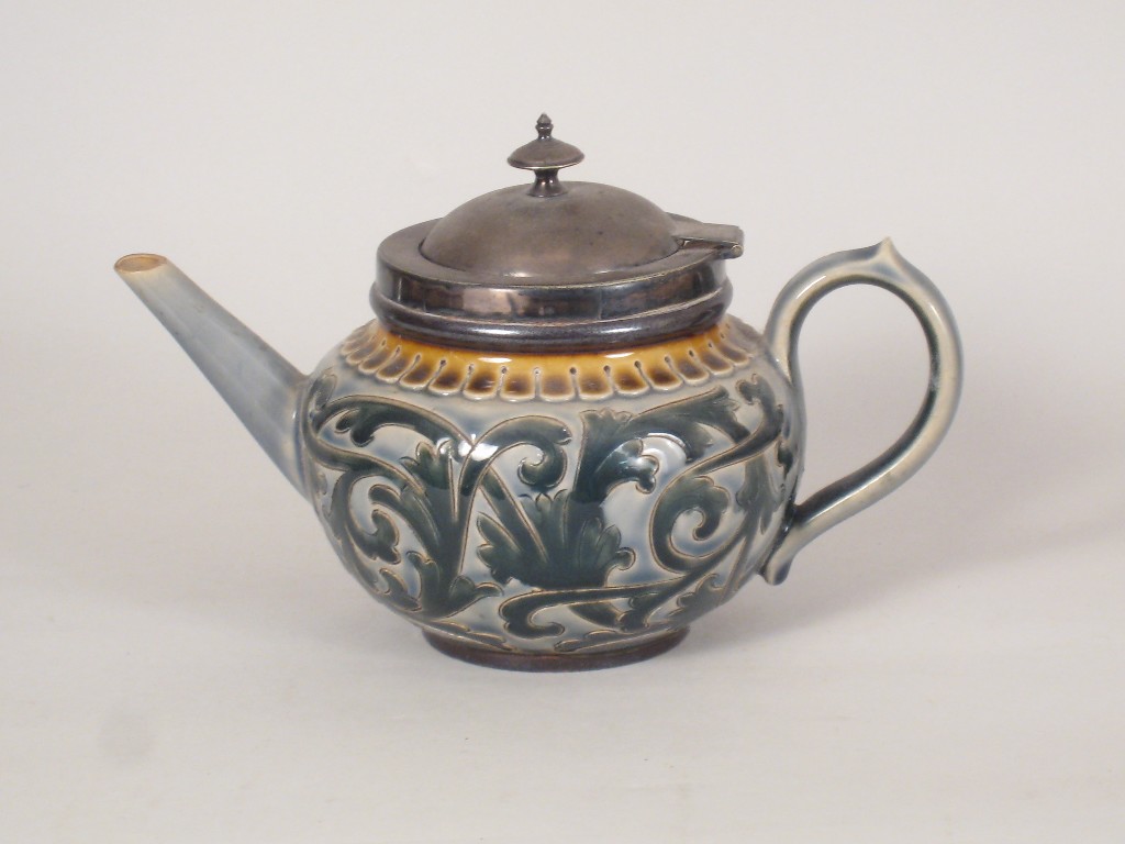 Appraisal: A Doulton Lambeth stoneware Teapot with incised leafage scroll design