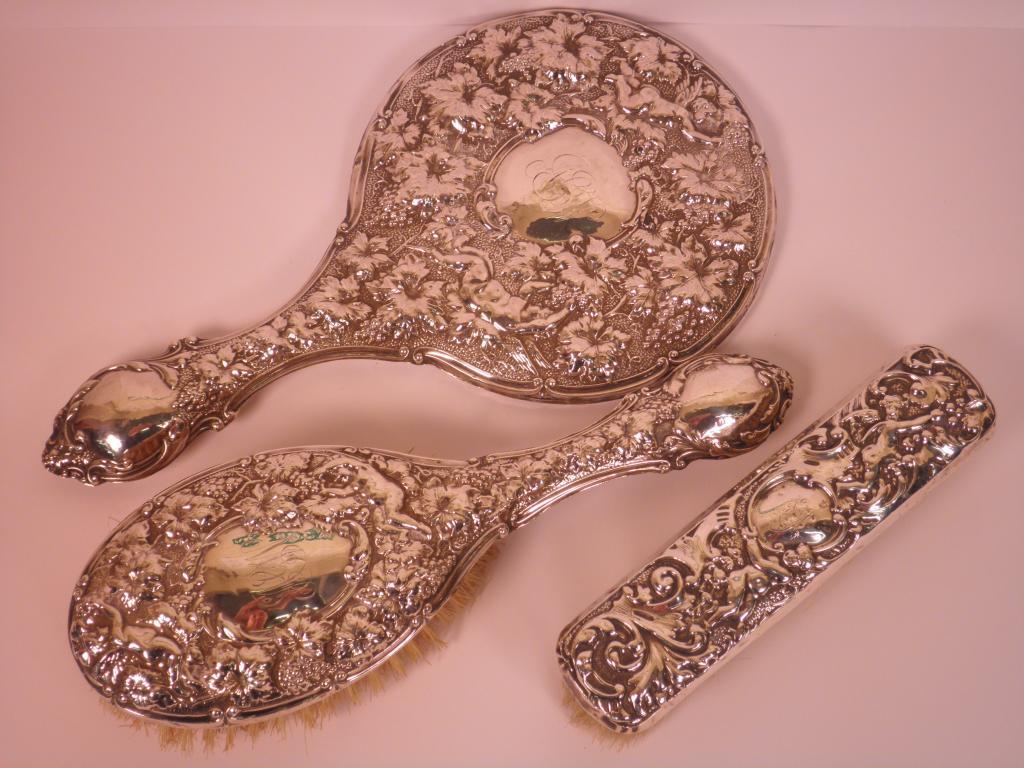 Appraisal: An Edwardian silver dressing mirror embossed with vines grapes and