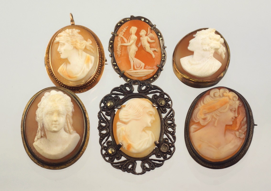 Appraisal: carved shell cameo portrait pins unmarked YG silver with marcasites