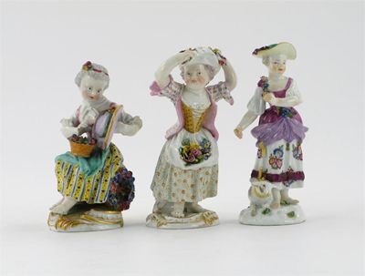 Appraisal: Three Meissen figures of young girls with hats aprons and