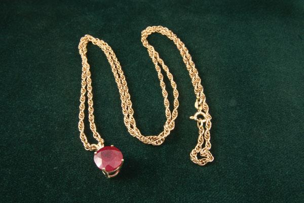 Appraisal: A large Ruby and Diamond Pendant simply claw-set with oval