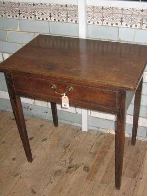 Appraisal: AN OAK SIDE TABLE the moulded edged rounded oblong top