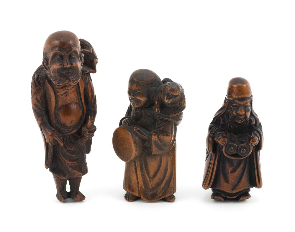 Appraisal: THREE JAPANESE CARVED WOOD FIGURAL NETSUKE MEIJI PERIODTHREE JAPANESE CARVED