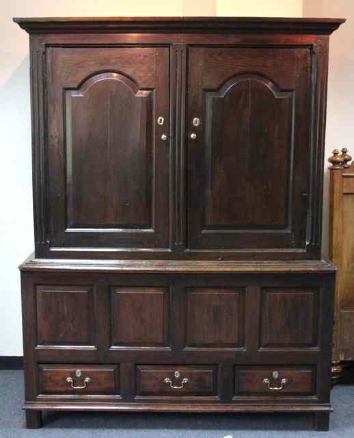 Appraisal: An th Century oak wardrobe with two arched and fielded