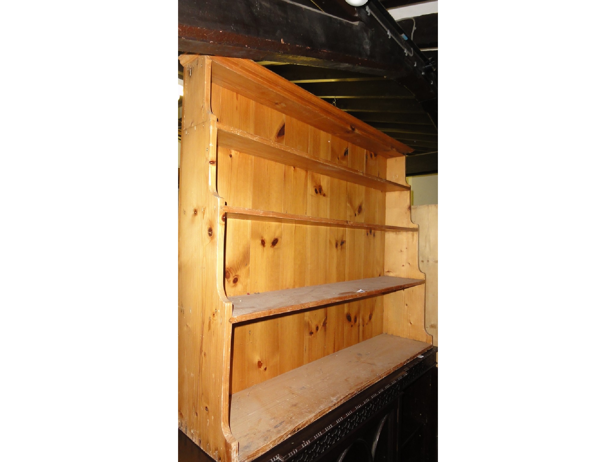 Appraisal: A stripped pine floorstanding waterfall type bookcase with fixed open